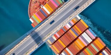 Container Ship passing underneath a road bridge